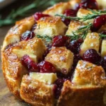Delicious pull-apart sourdough brie and cranberry bread fresh from the oven