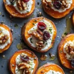 Roasted sweet potato rounds topped with herbed ricotta, walnuts, and cranberries