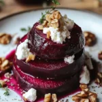 Rustic beet and goat cheese stacks with walnut thyme vinaigrette on a plate