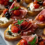 Rustic Italian bruschetta with prosciutto and burrata cheese on a wooden board