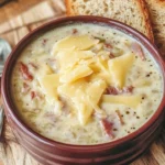A bowl of savory Reuben Soup garnished with herbs and ingredients.