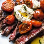 Seared skirt steak served with garlic blistered tomatoes and creamy burrata.