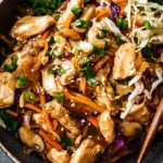 Sesame-Ginger Chicken stir-fry with colorful vegetables on a plate