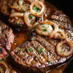 Sirloin steaks served with caramelized onion cream sauce on a plate