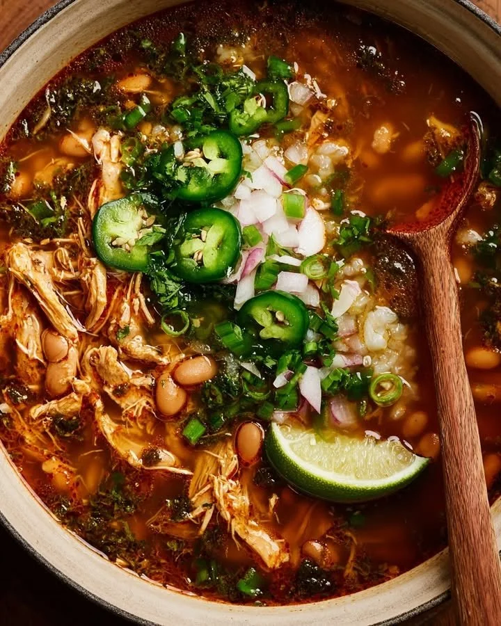 Bowl of Smoky Chicken, Bean & Rice Soup with fresh herbs.