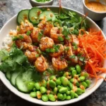 Delicious spicy shrimp rice bowl topped with fresh vegetables and herbs