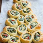 Spinach artichoke Christmas tree rolls baked and garnished for holiday parties