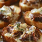 Delicious Steak and French Onion Bruschetta topped with herbs and cheese