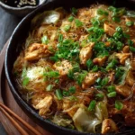 Stir-fried chicken with Napa cabbage and glass noodles served in a bowl