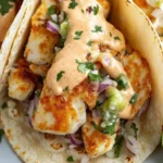 Zesty fish tacos with spicy sriracha lime sauce on a plate