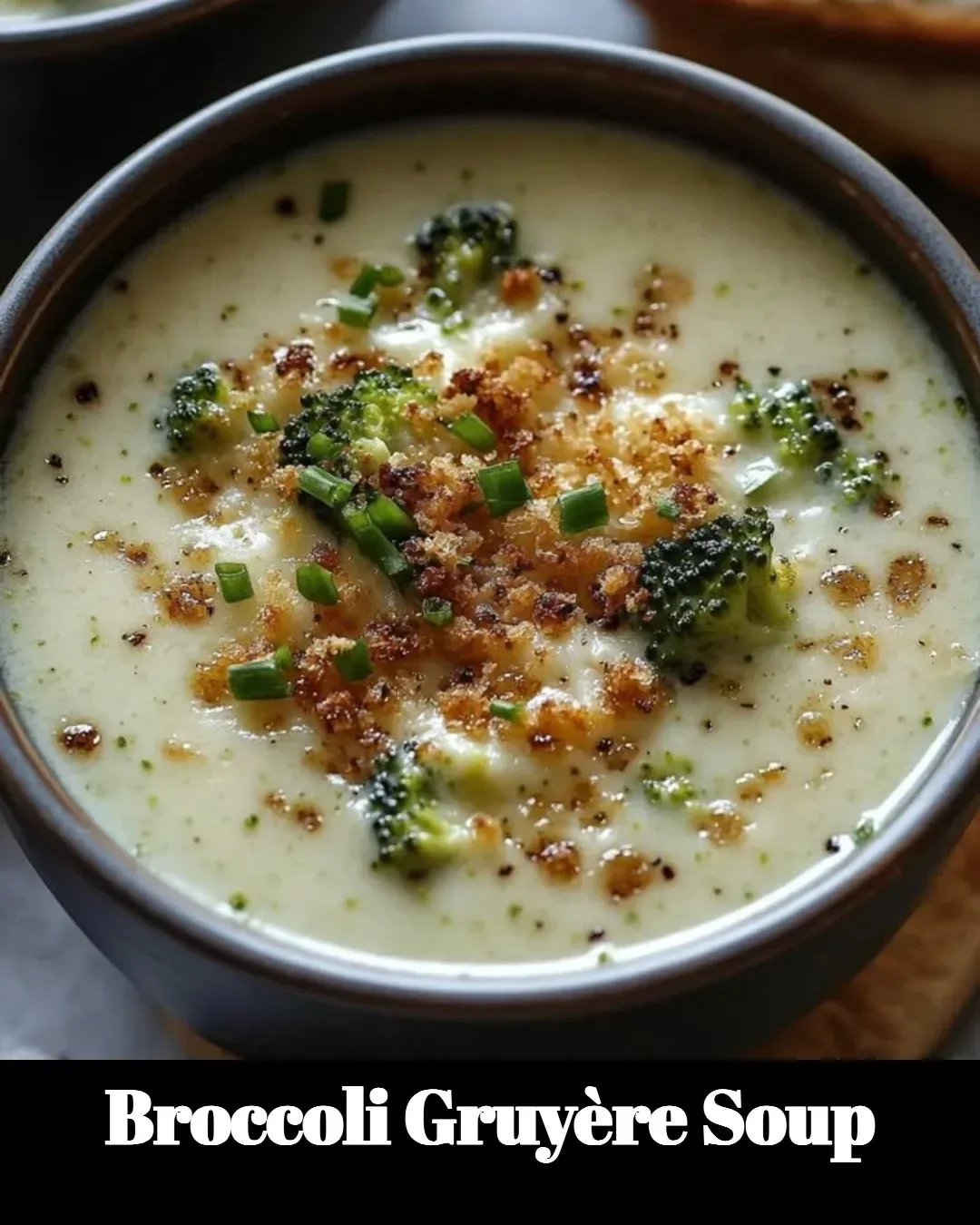 Delicious Broccoli Gruyère Soup served in a bowl with fresh herbs