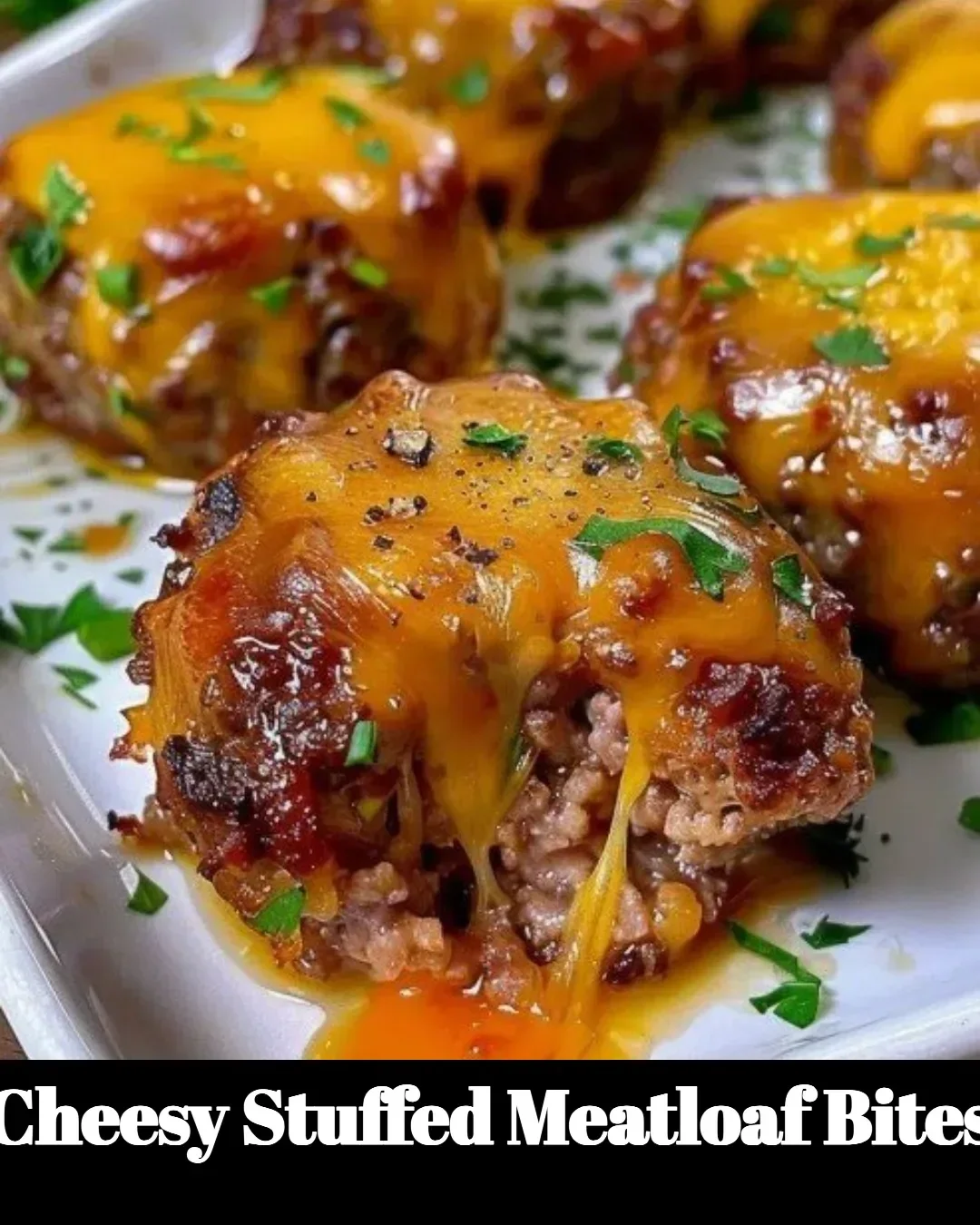 Cheesy stuffed meatloaf bites arranged on a platter, served as a tasty appetizer.