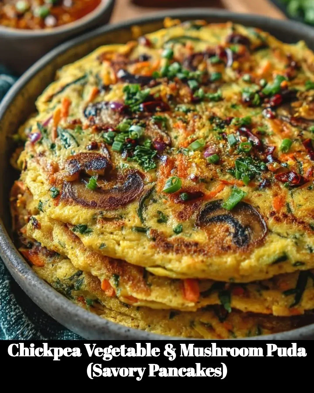 Chickpea Vegetable and Mushroom Puda savory pancakes plated with fresh herbs.