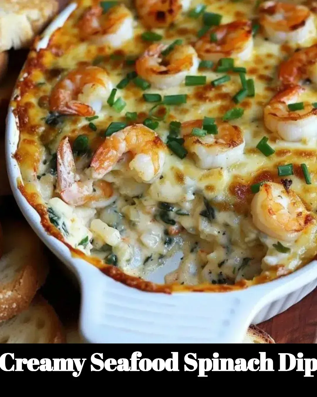 Bowl of creamy seafood spinach dip with crackers on a wooden table