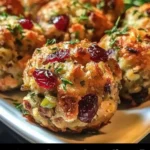 Festive cranberry turkey stuffing balls on a serving platter.