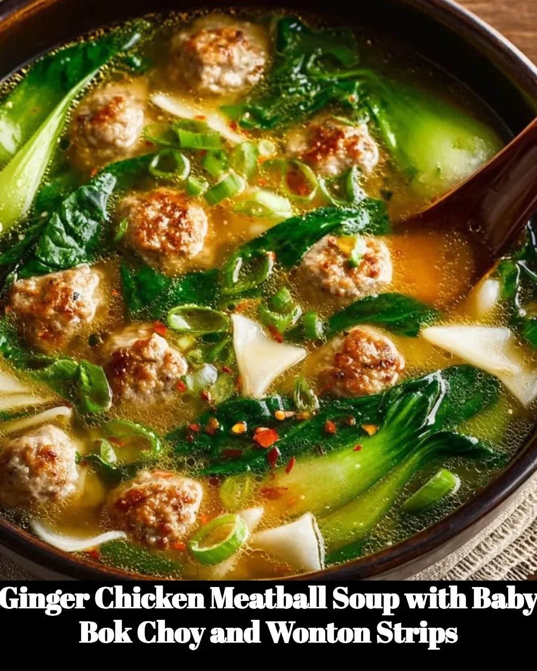 Ginger Chicken Meatball Soup with Baby Bok Choy and Wonton Strips in a bowl