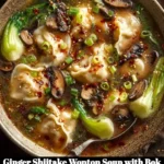 Bowl of Ginger Shiitake Wonton Soup with Bok Choy and Lemon garnished beautifully.
