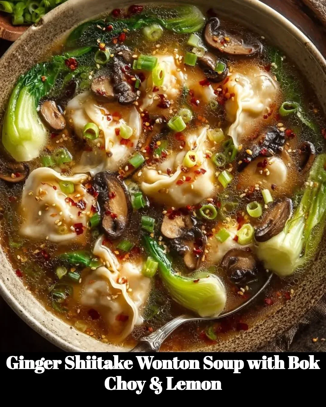 Bowl of Ginger Shiitake Wonton Soup with Bok Choy and Lemon garnished beautifully.