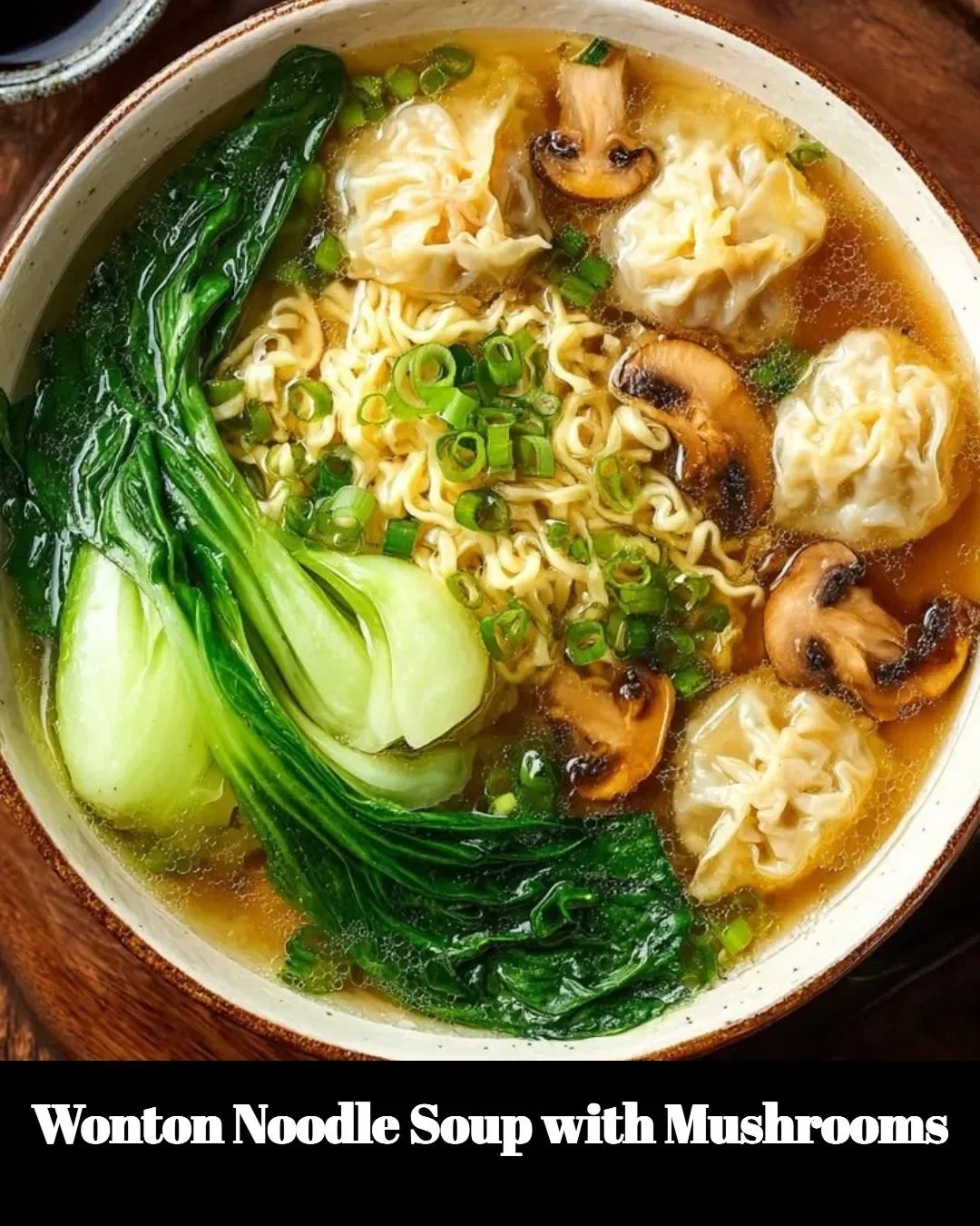 Bowl of wonton noodle soup with mushrooms garnished with green onions