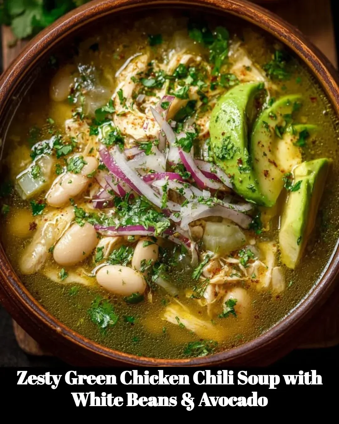 Zesty green chicken chili soup with white beans and avocado garnishing