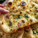 Freshly baked authentic artisan garlic naan with herbs and garlic
