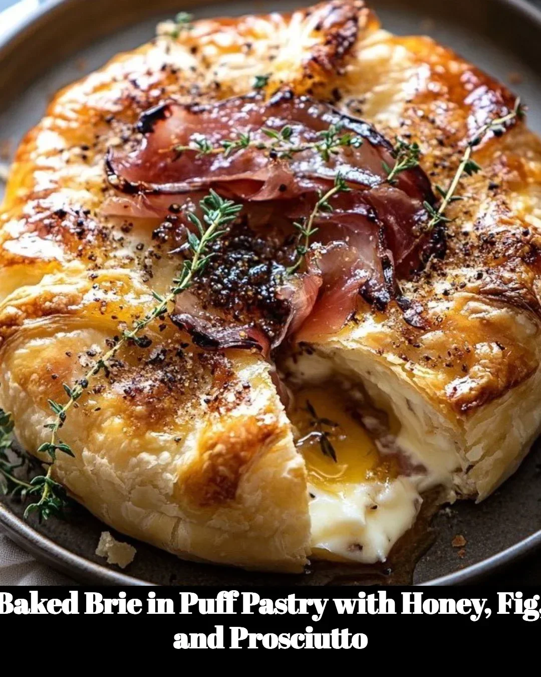 Baked brie in puff pastry with honey, fig, and prosciutto on a serving platter