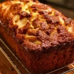 Delicious homemade Banana Applesauce Bread slice on a wooden table