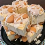 Delicious Banana Pudding Cheesecake Squares topped with banana slices and whipped cream