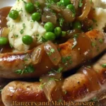 Plate of Bangers and Mash with sausage topped with onion gravy