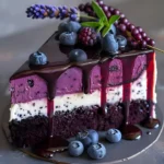 Sliced blueberry lavender cake decorated with fresh blueberries and lavender sprigs.