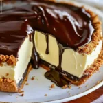 Delicious Boston Cream Pie Cheesecake slice topped with chocolate glaze