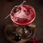 Bourbon cherry cocktail garnished with fresh cherries and mint