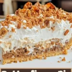 Delicious Butterfinger Pie topped with chocolate and crushed Butterfinger bars.