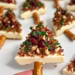 Tasty Candied Pecan & Cranberry Brie Bites served on a decorative platter.