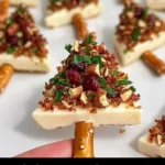 Delicious candied pecan and cranberry brie bites on a serving platter