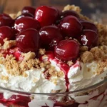 Delicious Cherry Cheesecake Fluff dessert served in a bowl with cherries on top.