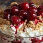 Delicious Cherry Cheesecake Fluff dessert in a bowl with cherries on top