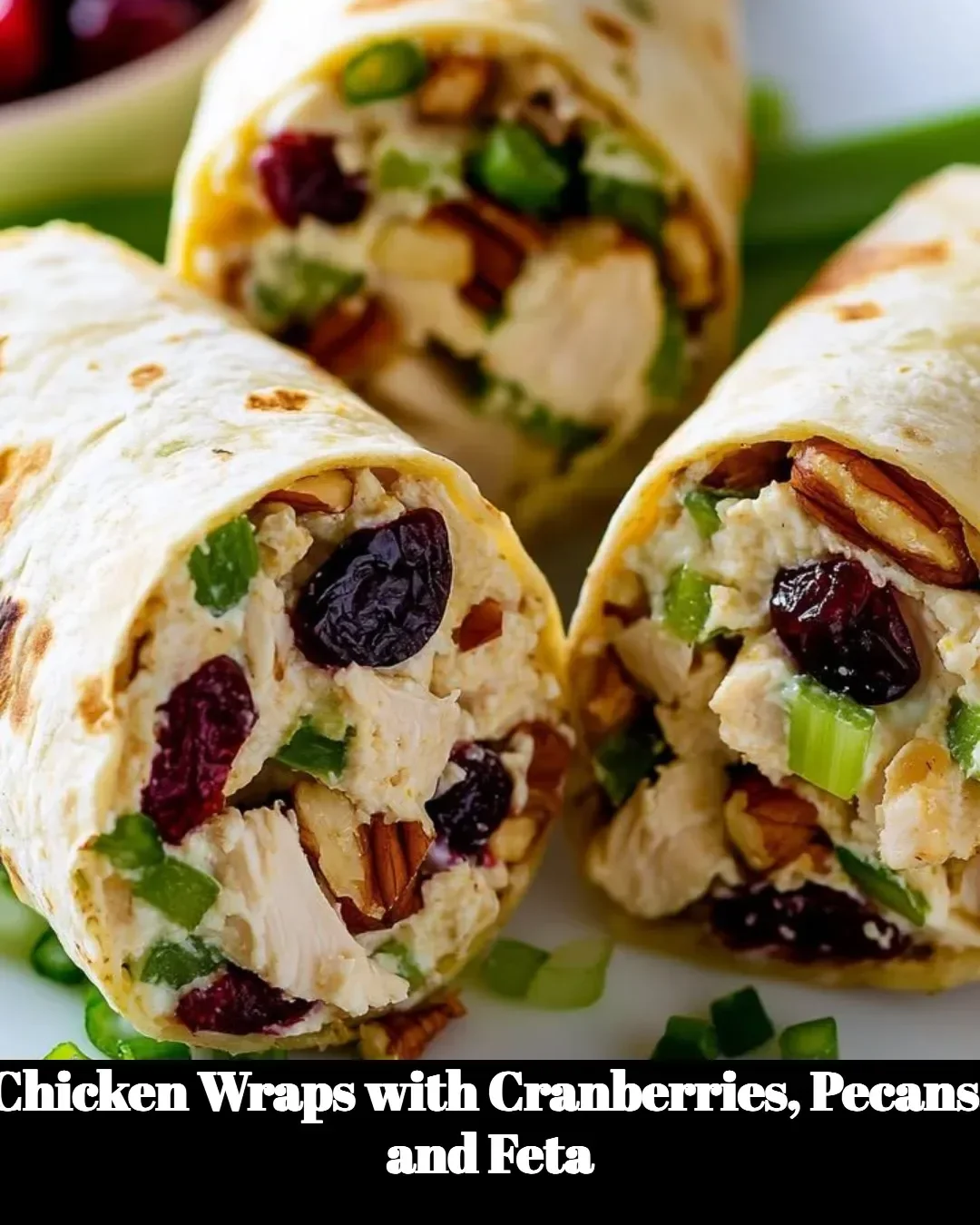 Chicken wraps featuring cranberries, pecans, and feta cheese on a plate