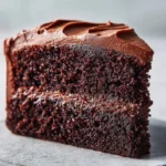Delicious slice of Chocolate Mayonnaise Cake on a plate with chocolate frosting