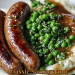 Plate of classic sausage and mash served with peas.