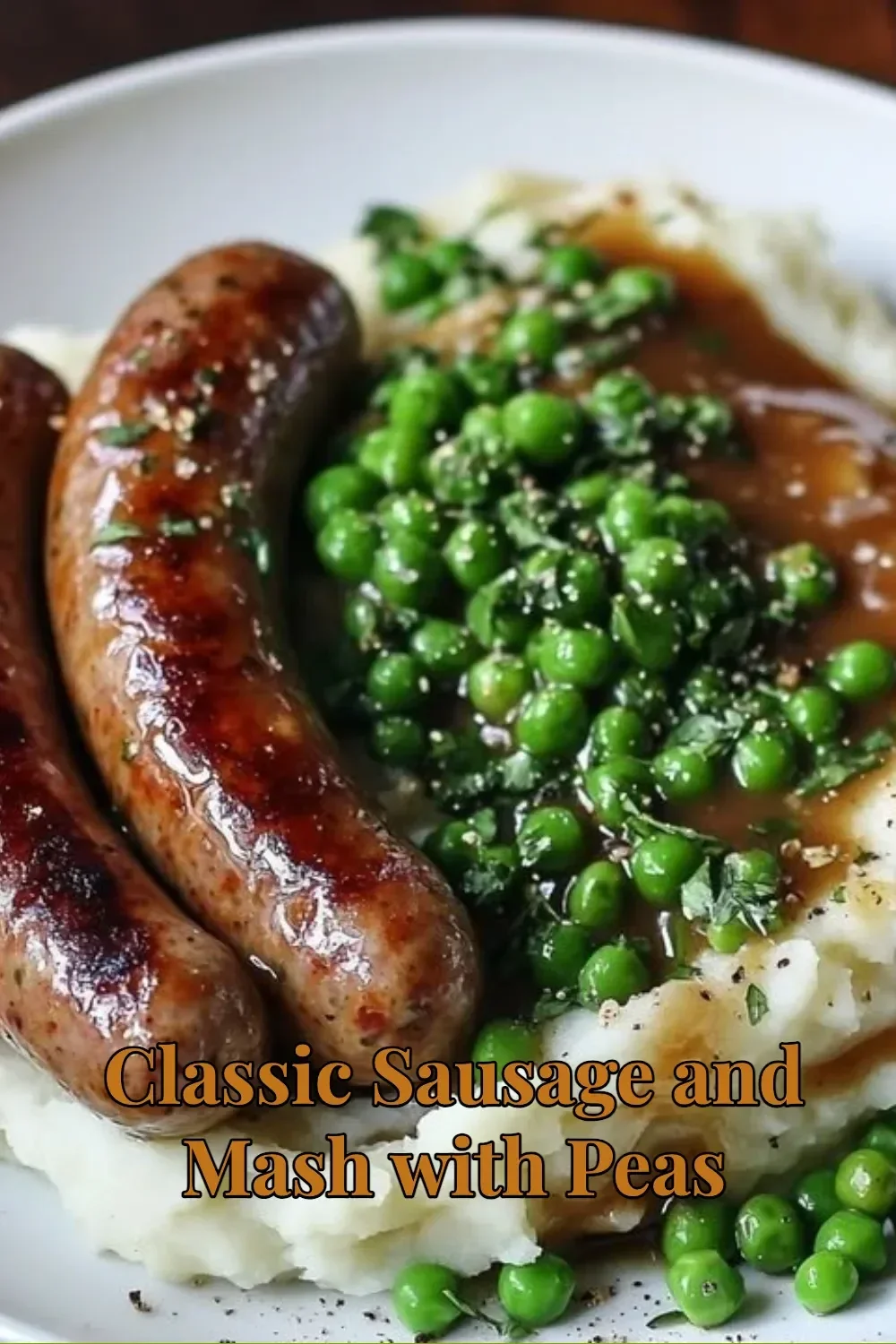 Plate of classic sausage and mash served with peas.