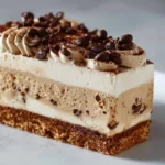 Sliced coffee ice cream cake with coffee beans and chocolate decor