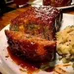 Delicious Cracker Barrel-style meatloaf served with sides