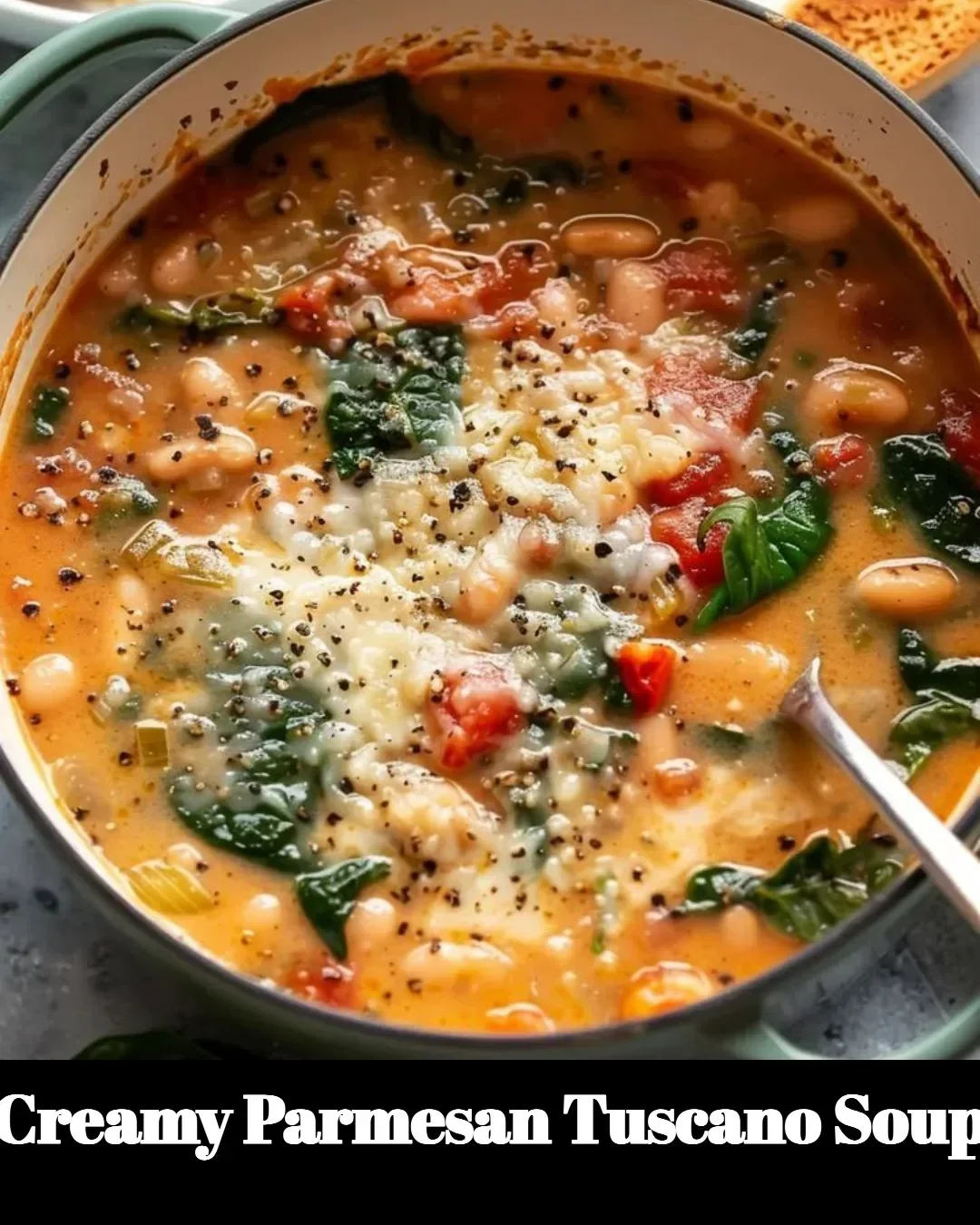 Bowl of Creamy Parmesan Tuscano Soup topped with herbs and cheese, served hot.
