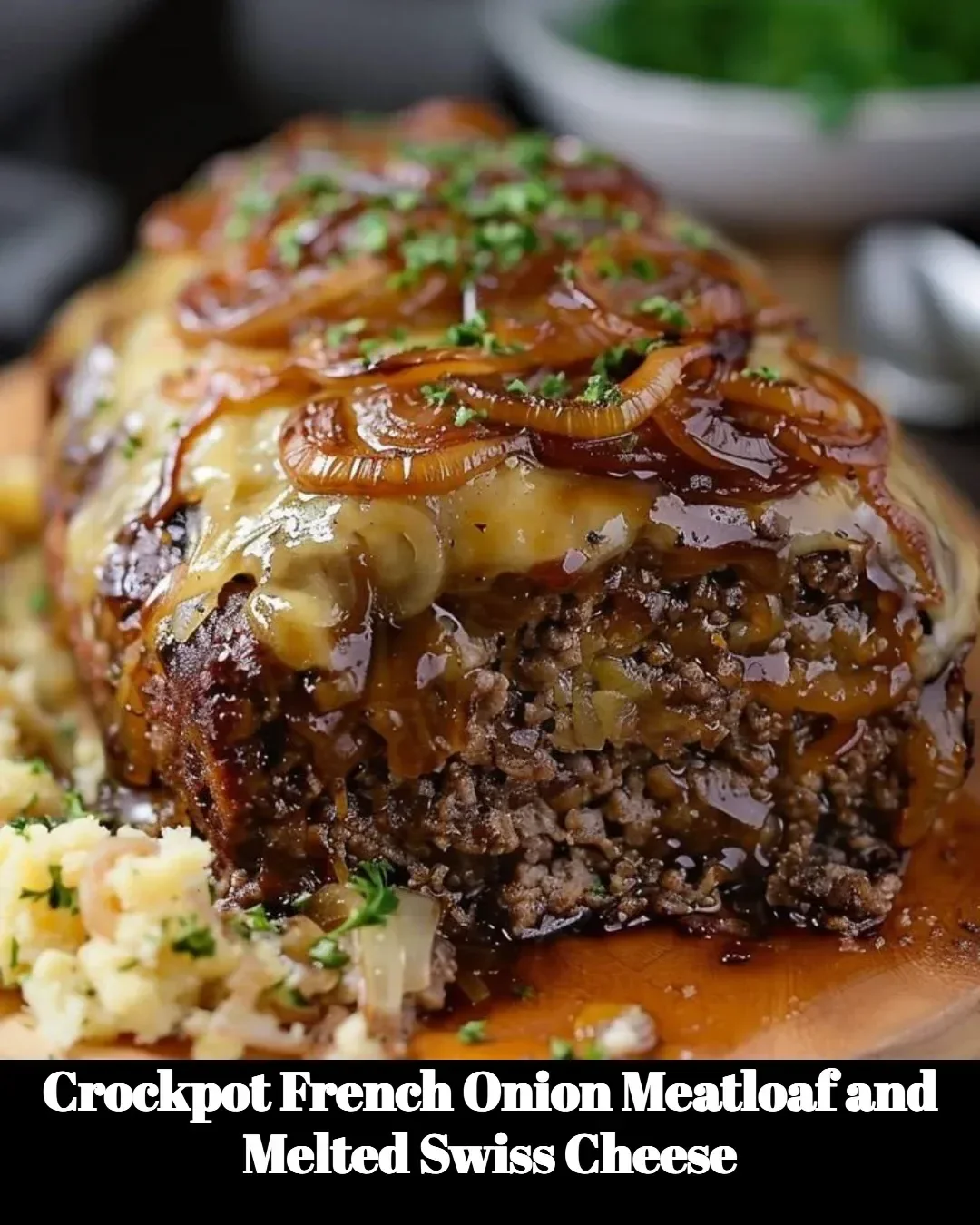 Crockpot French Onion Meatloaf with melted Swiss cheese served on a plate