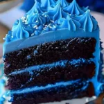 A beautiful slice of Divine Blue Velvet Cake showcasing its rich color and texture.