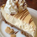 Elegant white chocolate peanut butter cheesecake topped with creamy decoration.