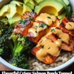 Crispy salmon bowls drizzled with creamy Bang Bang sauce served in a vibrant dish