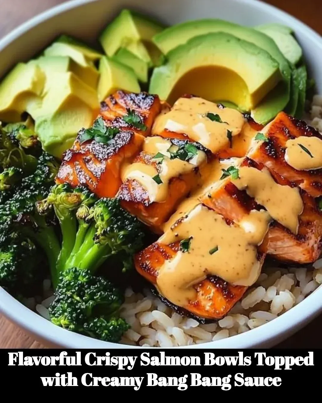 Crispy salmon bowls drizzled with creamy Bang Bang sauce served in a vibrant dish