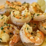 Plate of Garlic Butter Shrimp garnished with herbs and lemon.